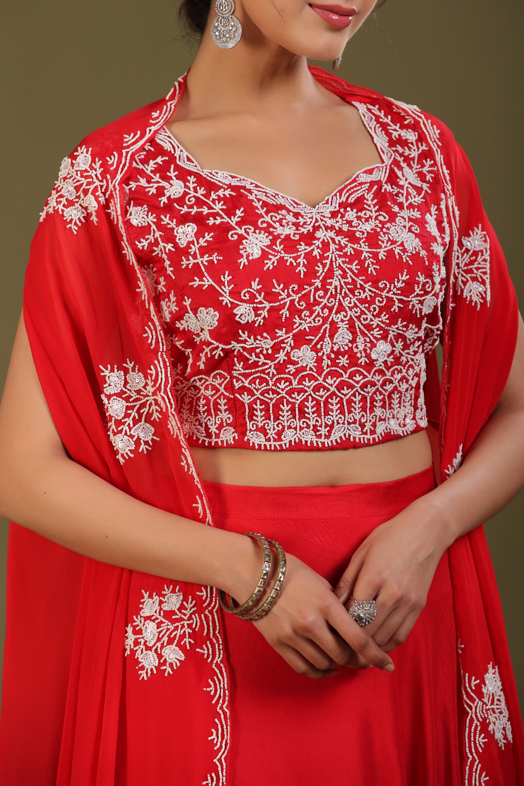 Beautiful silk set with a shrug and intricate detailing on the blouse and the shrug