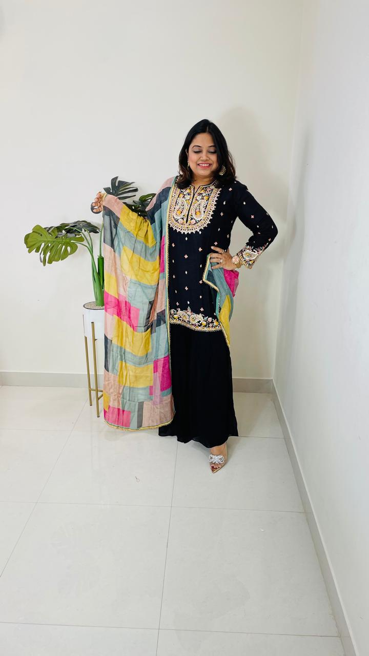 Beautiful dola silk kurta embellished with gotta work and paired with semi georgette sharara and a multi coloured organza dupattaComes with 2-4 inch margin